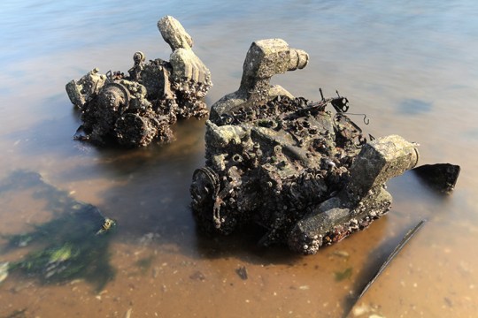 Barnacled motors stuck in the sand.