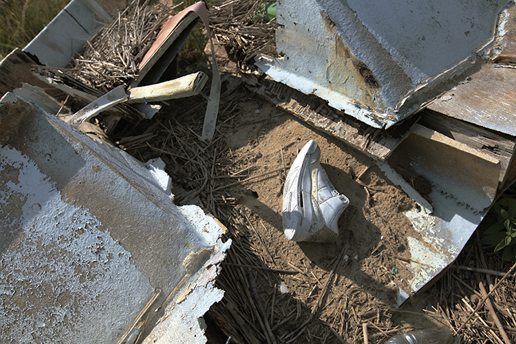 A single shoe stranded amid nautical debris.
