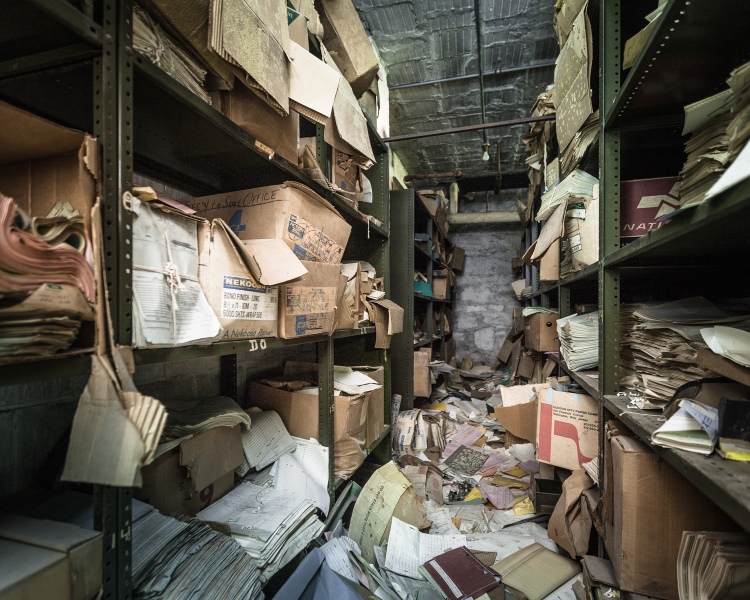 The file room contained 6 or 7 aisles of shelving piled high with records.